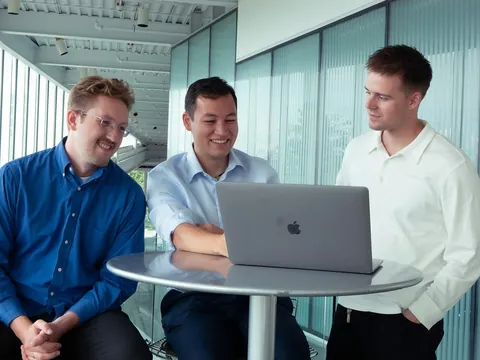 Archer Lawrence, Sean Sakaguchi, and Noah Latsch working together at a laptop.